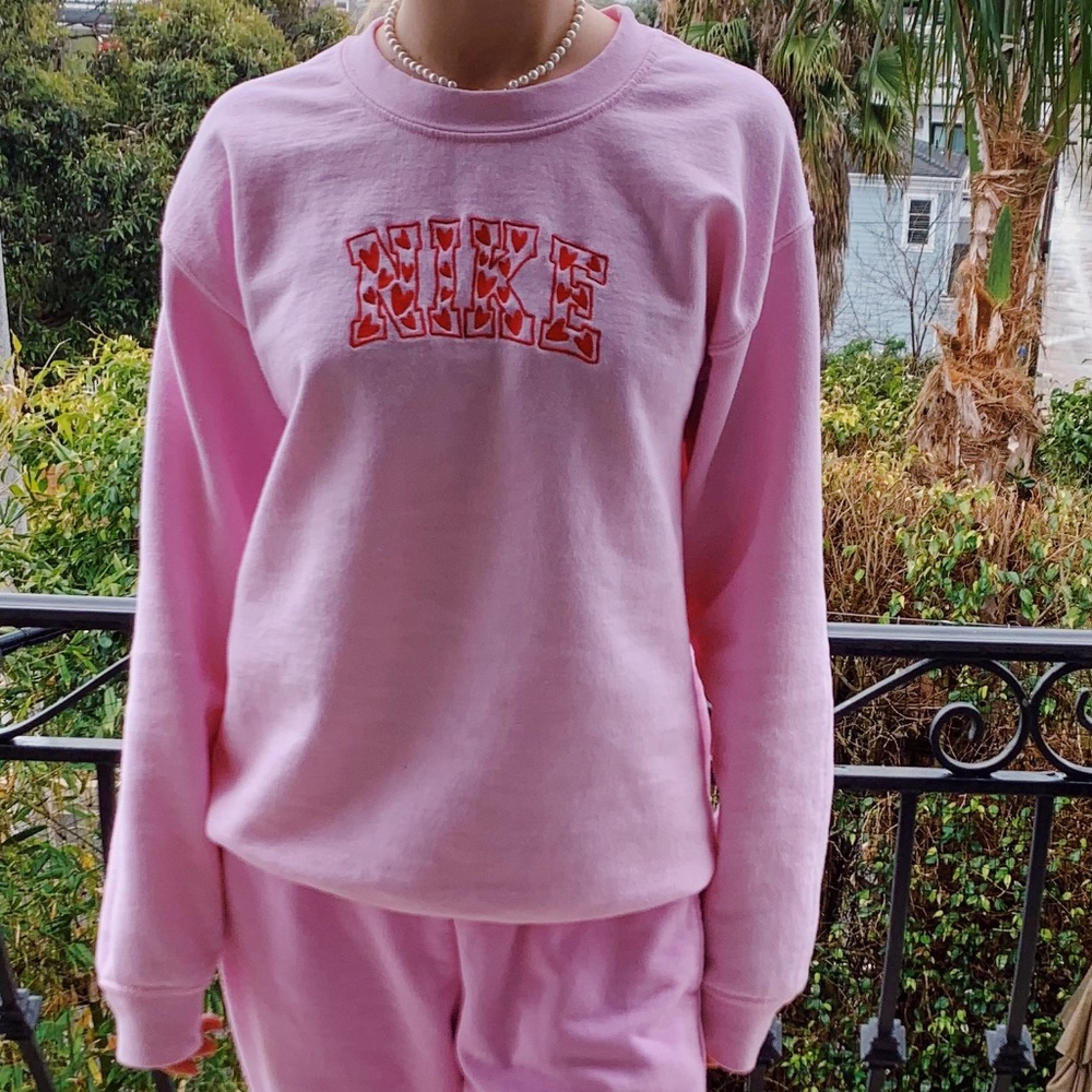 Pink crewneck with red "Nike" hearts design